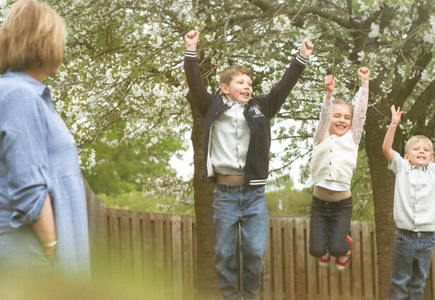 Grandmother observing her grandchildren playing during a fun and relaxed lifestyle photo session in Lincolnshire